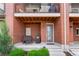 Covered porch with outdoor seating and front door of townhome at 7808 W 43Rd Pl, Wheat Ridge, CO 80033
