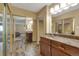 Bathroom with marble vanity, large mirror, and views into the main bedroom at 13961 E Marina Dr # 314, Aurora, CO 80014