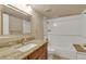 Well-lit bathroom featuring vanity with granite countertop, large mirror, and shower at 13961 E Marina Dr # 314, Aurora, CO 80014