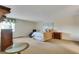 A large bedroom with neutral carpet, a queen-sized bed, and traditional furnishings at 13961 E Marina Dr # 314, Aurora, CO 80014