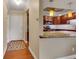 A view into the kitchen from the entryway, featuring updated appliances and a breakfast bar at 13961 E Marina Dr # 314, Aurora, CO 80014