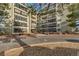 Multi-story condominium exterior featuring private balconies, well-maintained landscaping, and inviting entrance at 13961 E Marina Dr # 314, Aurora, CO 80014