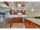 A well-lit kitchen featuring stainless steel appliances, wooden cabinetry, and granite countertops at 13961 E Marina Dr # 314, Aurora, CO 80014