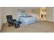 Comfortable bedroom featuring a plush chair with ottoman and ensuite bathroom access at 13961 E Marina Dr # 314, Aurora, CO 80014