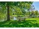 Scenic pond view with mature trees and a park bench offering a serene, shaded spot at 13961 E Marina Dr # 314, Aurora, CO 80014