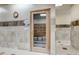 A wooden door leads to a dry sauna in a tile-walled room with lockers visible through the glass at 13961 E Marina Dr # 314, Aurora, CO 80014