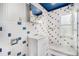 Unique bathroom featuring blue accents, subway tiles, and a walk-in shower for a refreshing experience at 4635 Teller St, Wheat Ridge, CO 80033