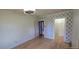 Empty bedroom features hardwood floors, white walls, with geometric-patterned accent wallpaper and ceiling fan with light at 4635 Teller St, Wheat Ridge, CO 80033