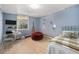 Digitally staged bedroom features wood flooring, a bright window, furniture, and decor at 4635 Teller St, Wheat Ridge, CO 80033