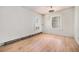 Bright bedroom with hardwood floors, two windows allowing natural light, and a rustic ceiling fan at 4635 Teller St, Wheat Ridge, CO 80033