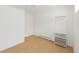 Bright bedroom with laminate flooring and closet with shelving and drawers at 4635 Teller St, Wheat Ridge, CO 80033