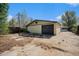 Detached garage with dark doors and yellow siding with space for vehicle parking at 4635 Teller St, Wheat Ridge, CO 80033