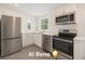 Recently remodeled Kitchen featuring stainless steel appliances and white cabinets, with ample countertop space at 4635 Teller St, Wheat Ridge, CO 80033