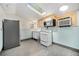 Kitchen with a skylight, appliances, and white cabinets; perfect for cooking and meal preparation at 4635 Teller St, Wheat Ridge, CO 80033