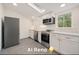 Recently remodeled Kitchen featuring stainless steel appliances and white cabinets, with ample countertop space at 4635 Teller St, Wheat Ridge, CO 80033