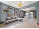 Bright living room with hardwood floors, classic light fixtures, and natural light from large windows at 4635 Teller St, Wheat Ridge, CO 80033