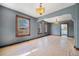 Bright living room with hardwood floors, classic light fixtures, and natural light from large windows at 4635 Teller St, Wheat Ridge, CO 80033