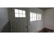 Functional mud room with white door, window, and wood paneling; perfect for transitioning from outdoors at 4635 Teller St, Wheat Ridge, CO 80033