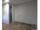Unfinished room featuring light blue walls and original wood flooring at 4635 Teller St, Wheat Ridge, CO 80033
