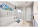 Bright bathroom features a large soaking tub with a shower and a granite countertop at 11727 Oswego St, Commerce City, CO 80640
