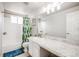 Bathroom features a shower-tub, a modern vanity with a granite countertop, and updated fixtures at 11727 Oswego St, Commerce City, CO 80640