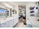 Bright bathroom with double sinks, modern fixtures, and a shower in the distance at 11727 Oswego St, Commerce City, CO 80640