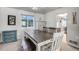 Cozy dining room featuring a modern table setting, ample natural light, and stylish cabinetry at 11727 Oswego St, Commerce City, CO 80640