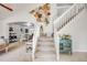 Grand entryway featuring a staircase and decorative wall art, connecting to the dining and living areas at 11727 Oswego St, Commerce City, CO 80640