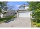 Traditional two-story home featuring manicured lawn and a two car garage in suburban neighborhood at 11727 Oswego St, Commerce City, CO 80640