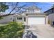 Traditional two-story home featuring manicured lawn and a two car garage in suburban neighborhood at 11727 Oswego St, Commerce City, CO 80640