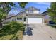 Charming two-story home with a well-maintained lawn at 11727 Oswego St, Commerce City, CO 80640