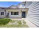 Inviting front porch with a stylish blue door and manicured garden, offering curb appeal and charm at 11727 Oswego St, Commerce City, CO 80640
