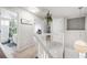 Upstairs hallway features a view into the updated bathroom and multiple bedrooms at 11727 Oswego St, Commerce City, CO 80640