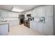 Bright kitchen features stainless appliances, granite counters, subway tile backsplash and tile flooring at 11727 Oswego St, Commerce City, CO 80640