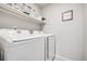 Laundry room features new white appliances and storage shelving at 11727 Oswego St, Commerce City, CO 80640