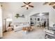 Bright living room and dining area combo with vaulted ceilings, plush carpet, and stylish decor at 11727 Oswego St, Commerce City, CO 80640
