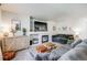Cozy living room features a fireplace, large television, and comfortable seating at 11727 Oswego St, Commerce City, CO 80640