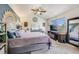 A calming main bedroom features a ceiling fan, large windows, and ample space for relaxation at 11727 Oswego St, Commerce City, CO 80640