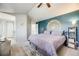 Spacious primary bedroom with an accent wall, plush bedding, and stylish decor at 11727 Oswego St, Commerce City, CO 80640