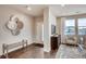 Stylish entryway boasts hardwood floors, modern decor, and abundant natural light from a large window at 6570 Parterre N Pkwy # 6, Thornton, CO 80602