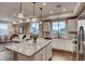 Open-concept kitchen with island, modern appliances, and view into the living room at 6570 Parterre N Pkwy # 6, Thornton, CO 80602