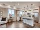 Bright kitchen with island, modern appliances, and view into the living room and dining area at 6570 Parterre N Pkwy # 6, Thornton, CO 80602