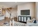Elegant living room with hardwood floors, gray rug, television, and staircase at 6570 Parterre N Pkwy # 6, Thornton, CO 80602