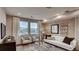 Bright and inviting living room features neutral tones, stylish furniture, and large windows at 6570 Parterre N Pkwy # 6, Thornton, CO 80602