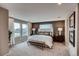 This spacious main bedroom features an accent wall, large windows, and a sitting area with a bench at 6570 Parterre N Pkwy # 6, Thornton, CO 80602