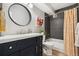 Updated bathroom featuring dark gray tile, stylish vanity, and a tub with a patterned shower curtain at 7040 E Girard Ave # 207, Denver, CO 80224