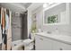 Cozy bathroom with a tiled shower, modern vanity, and decorative plant accents at 7040 E Girard Ave # 207, Denver, CO 80224