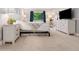 Cozy bedroom featuring a comfortable bed, dresser, and bright windows at 7040 E Girard Ave # 207, Denver, CO 80224