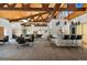 Well-appointed community room with a bar, tables, and a pool table beneath a striking beamed ceiling at 7040 E Girard Ave # 207, Denver, CO 80224