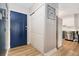 Bright entryway with a blue front door, wood-look flooring, coat closet and stainless steel appliances at 7040 E Girard Ave # 207, Denver, CO 80224